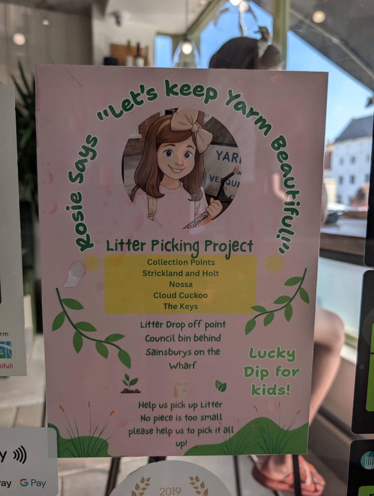 Rosie Says campaign poster in a Yarm shop window, listing the four litter picking kit collection points and the drop off point behind Sainsbury's